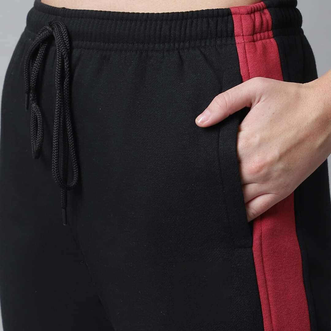Close-up of pocket and side stripe on track pants